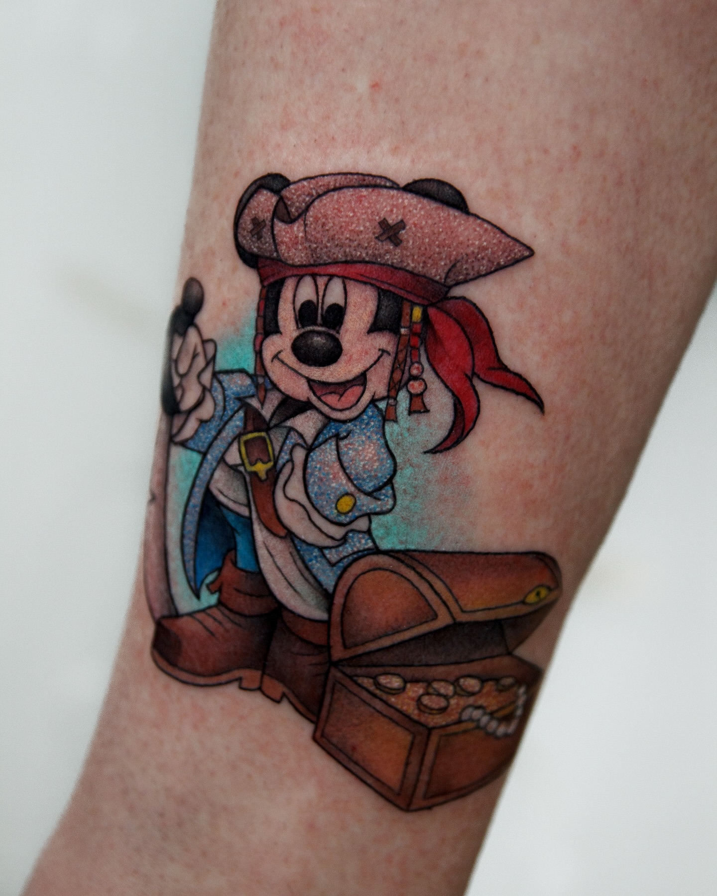 Pirate mickey mouse illustrative tattoo on the forearm by caliope yiannos