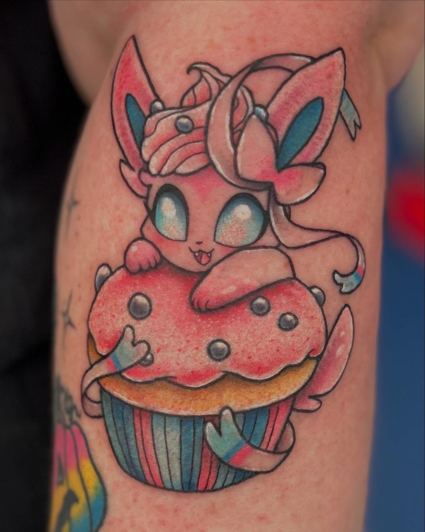 Cupcake with character new school tattoo on the forearm by Abby Watts, Columbus, Ohio
