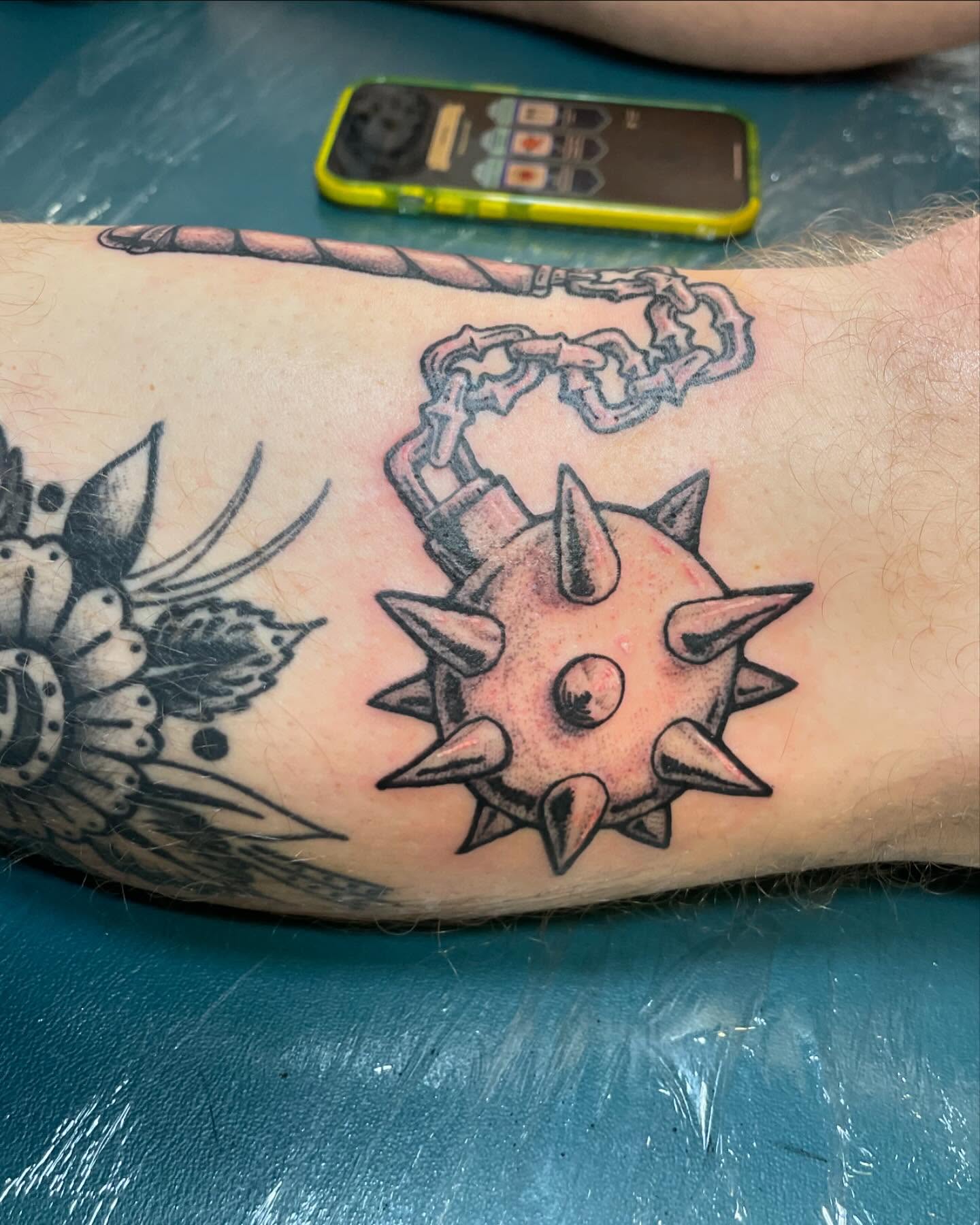 Spiked ball and chain neo-traditional tattoo on the forearm by Evan