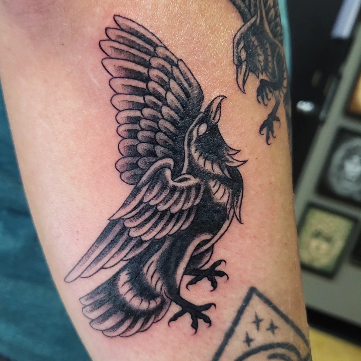 Crow black and grey tattoo on the forearm by Brenda Juarez - Tattoo Artist