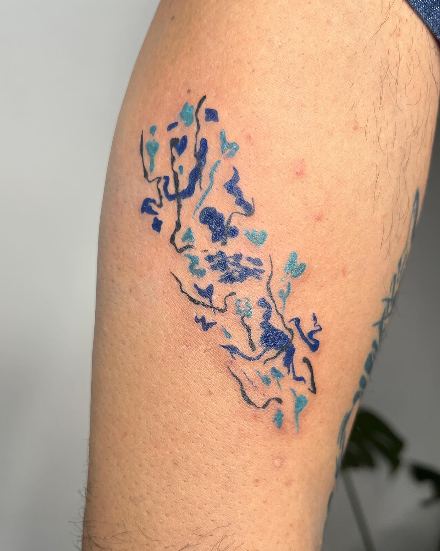 Abstract watercolor watercolor tattoo on the forearm by tattoos by quin
