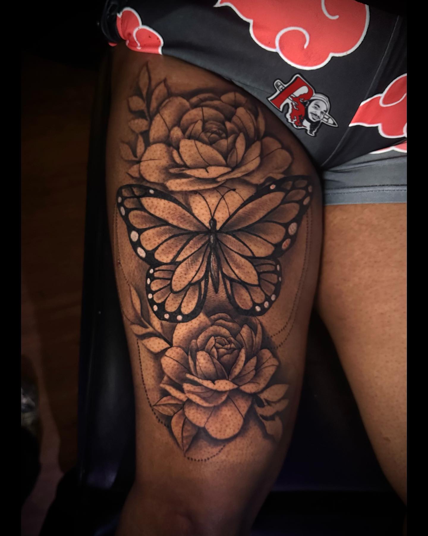Monarch butterfly and roses realism tattoo on the thigh by Chicago Tattoo Artist