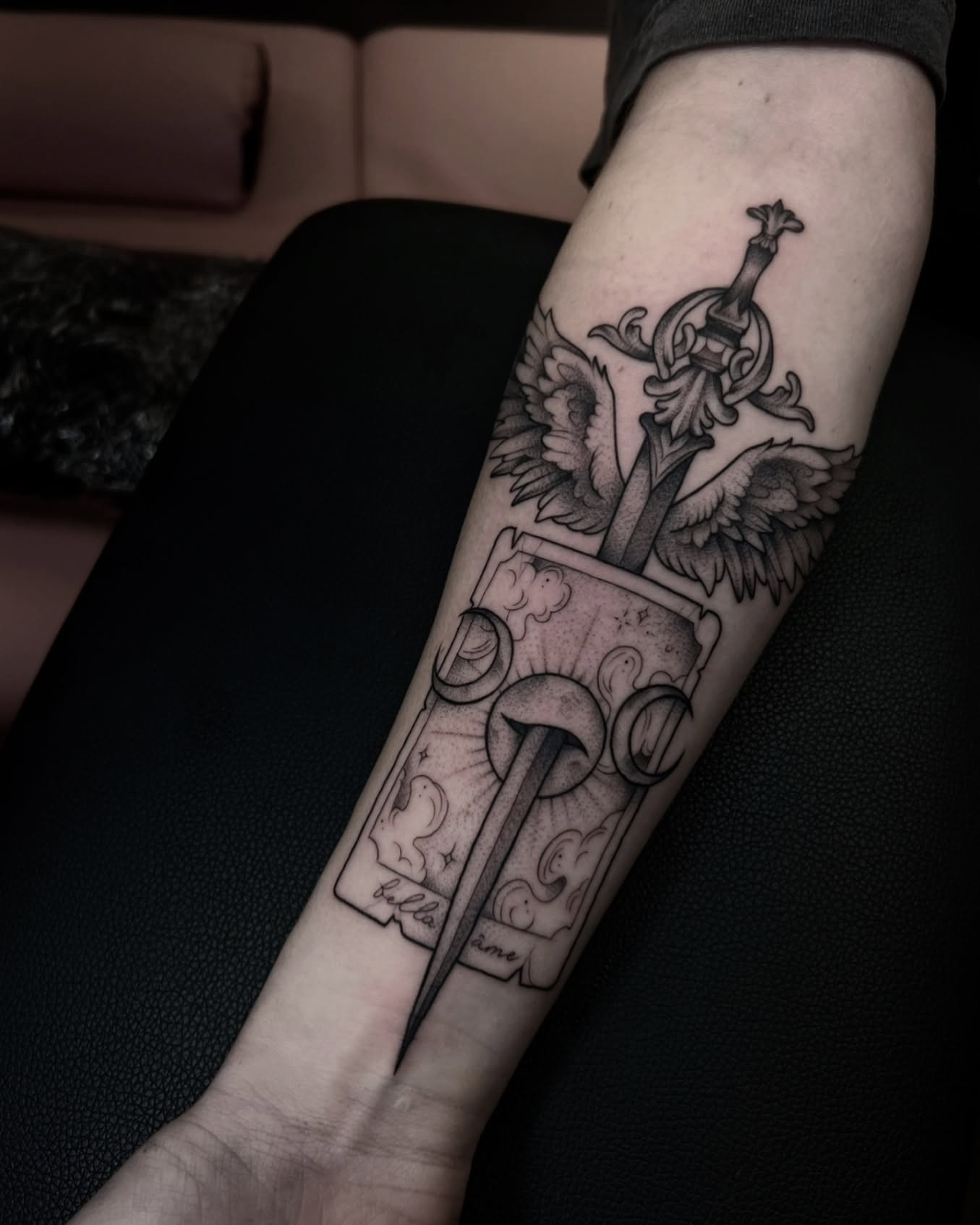 Sword and eagle black and grey tattoo on the forearm by Chloe