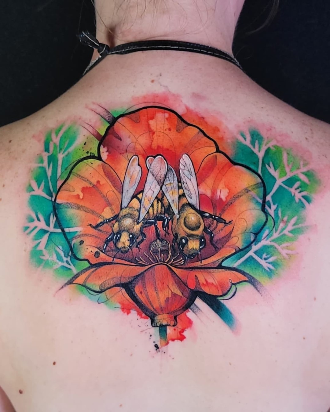 Bees in flower watercolor tattoo on the back by Jorell Elie