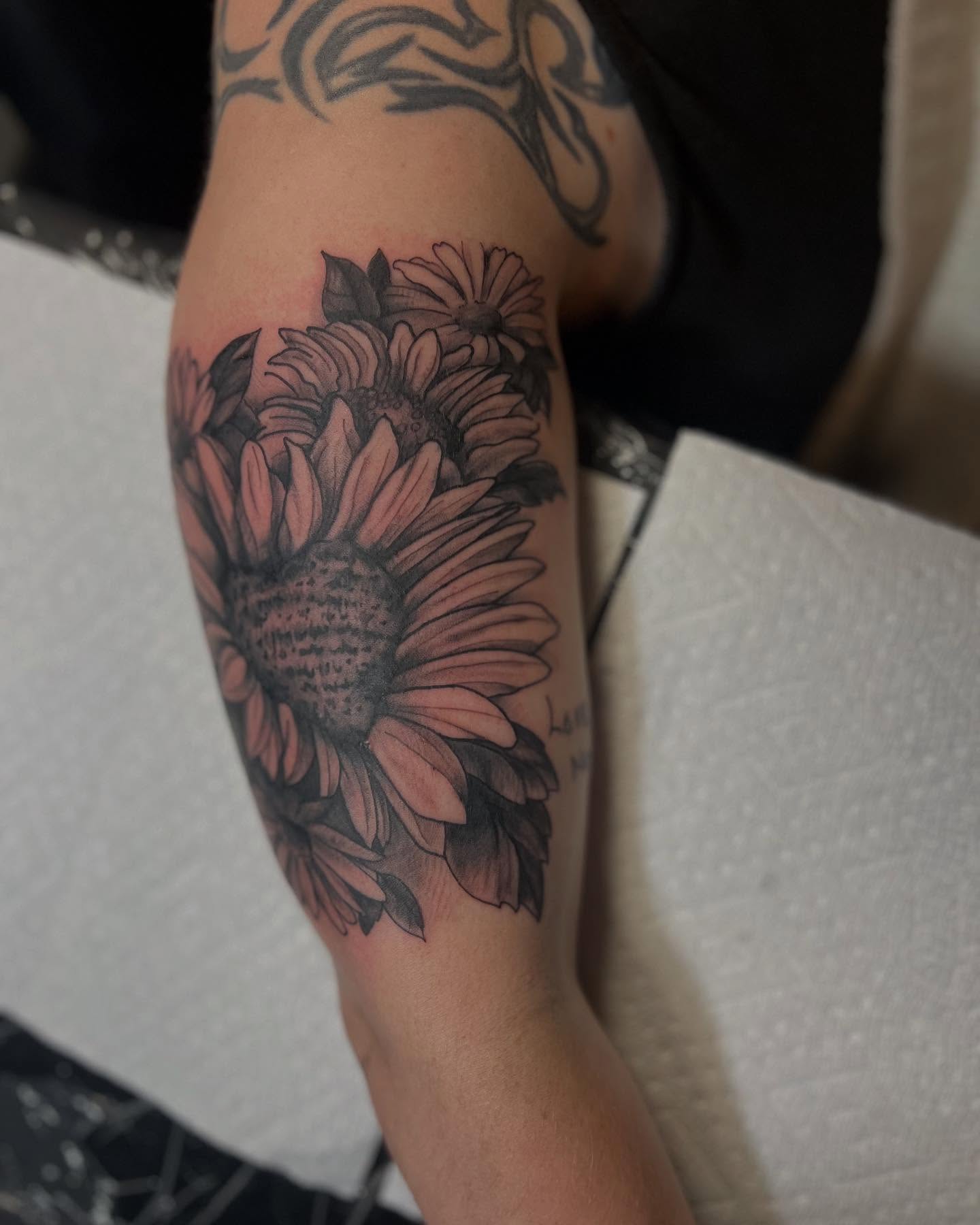 Sunflower black and grey tattoo on the forearm by Katie Sayre
