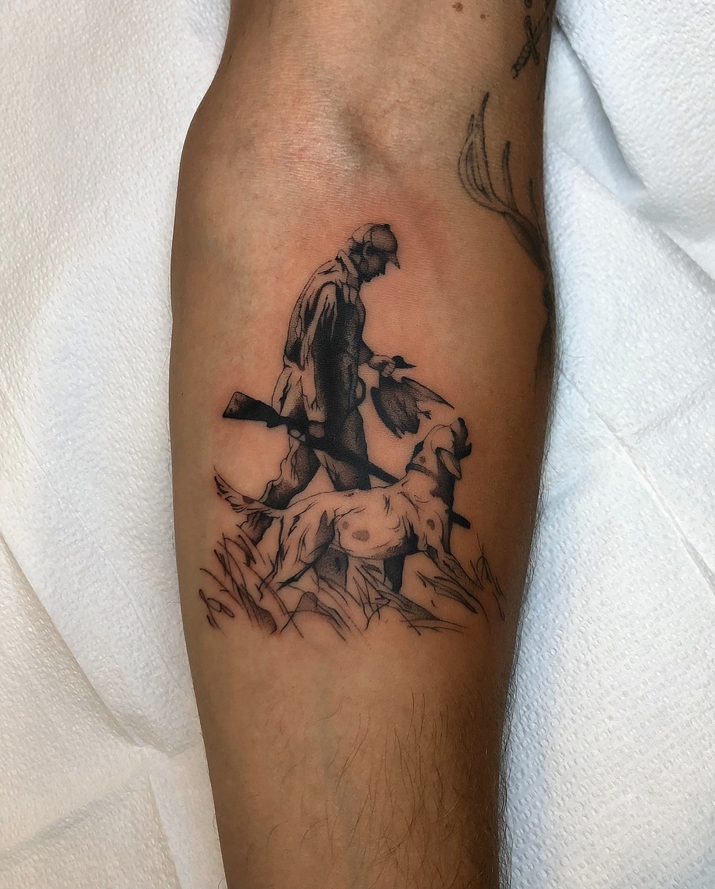 Man with bird black and grey tattoo on the forearm by Mickey