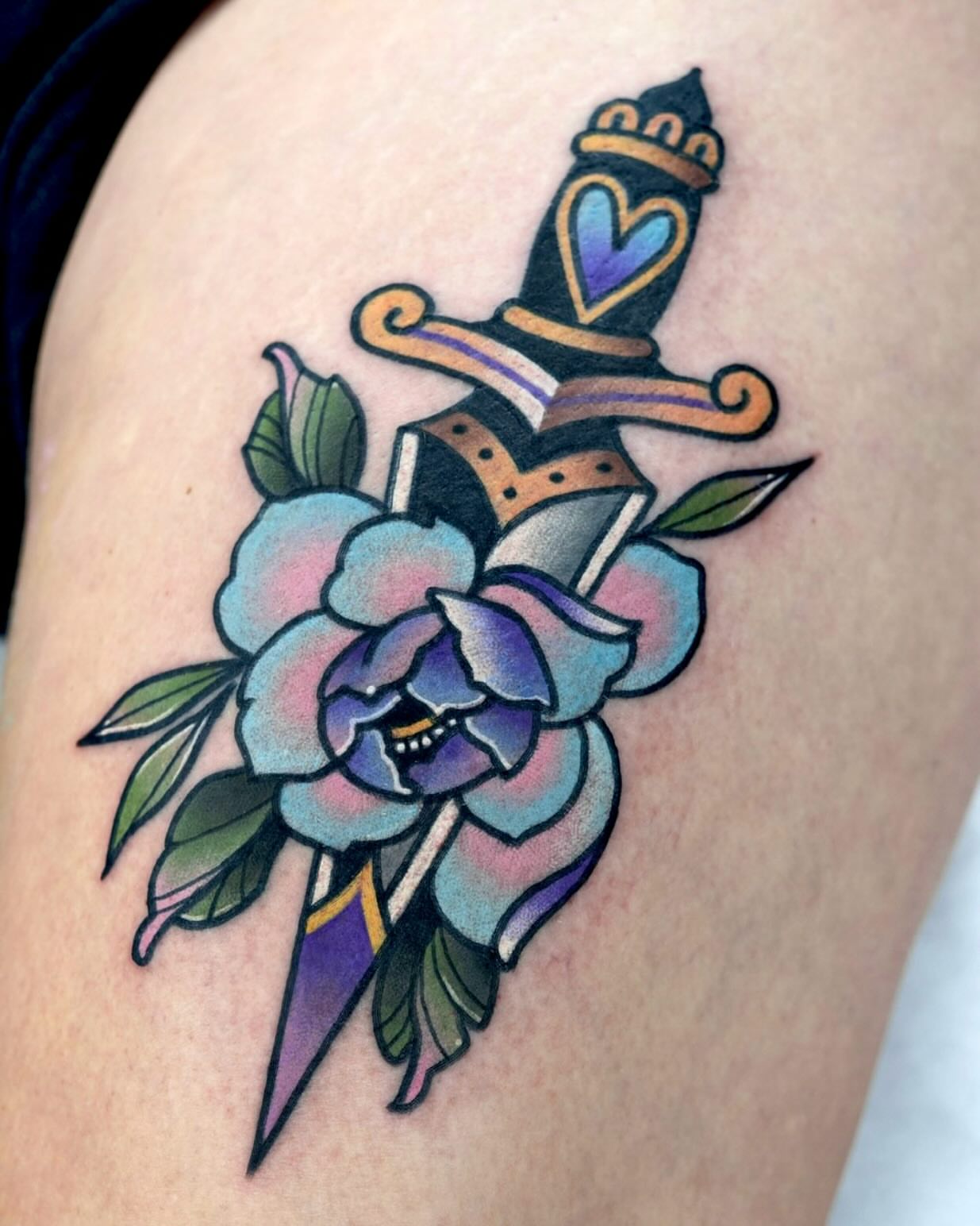 Knife and flower American traditional tattoo on the thigh by 부산타투