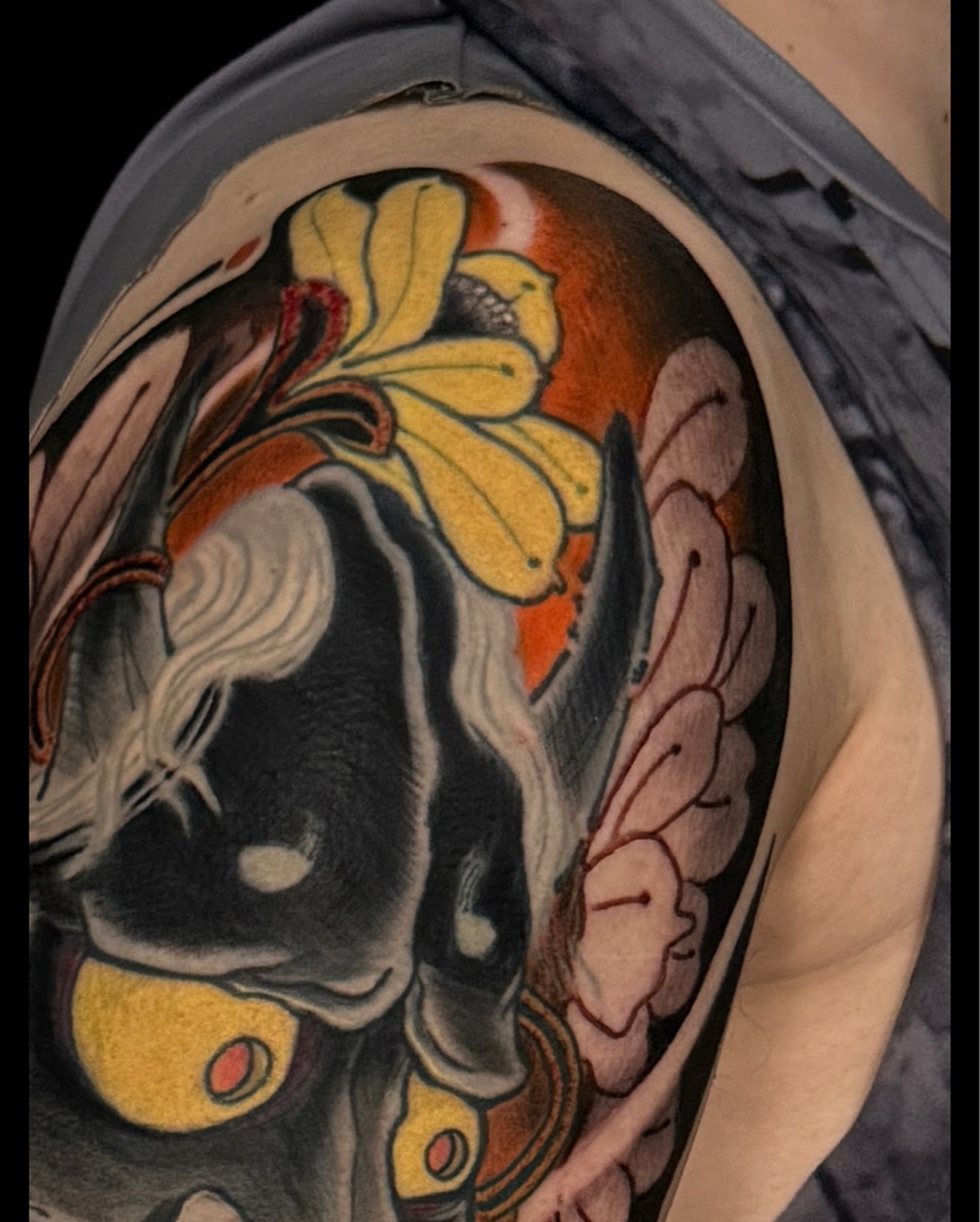 Mask with flower American traditional tattoo on the shoulder by Las Vegas Japanese Tattoo Artist, Las Vegas, Nevada
