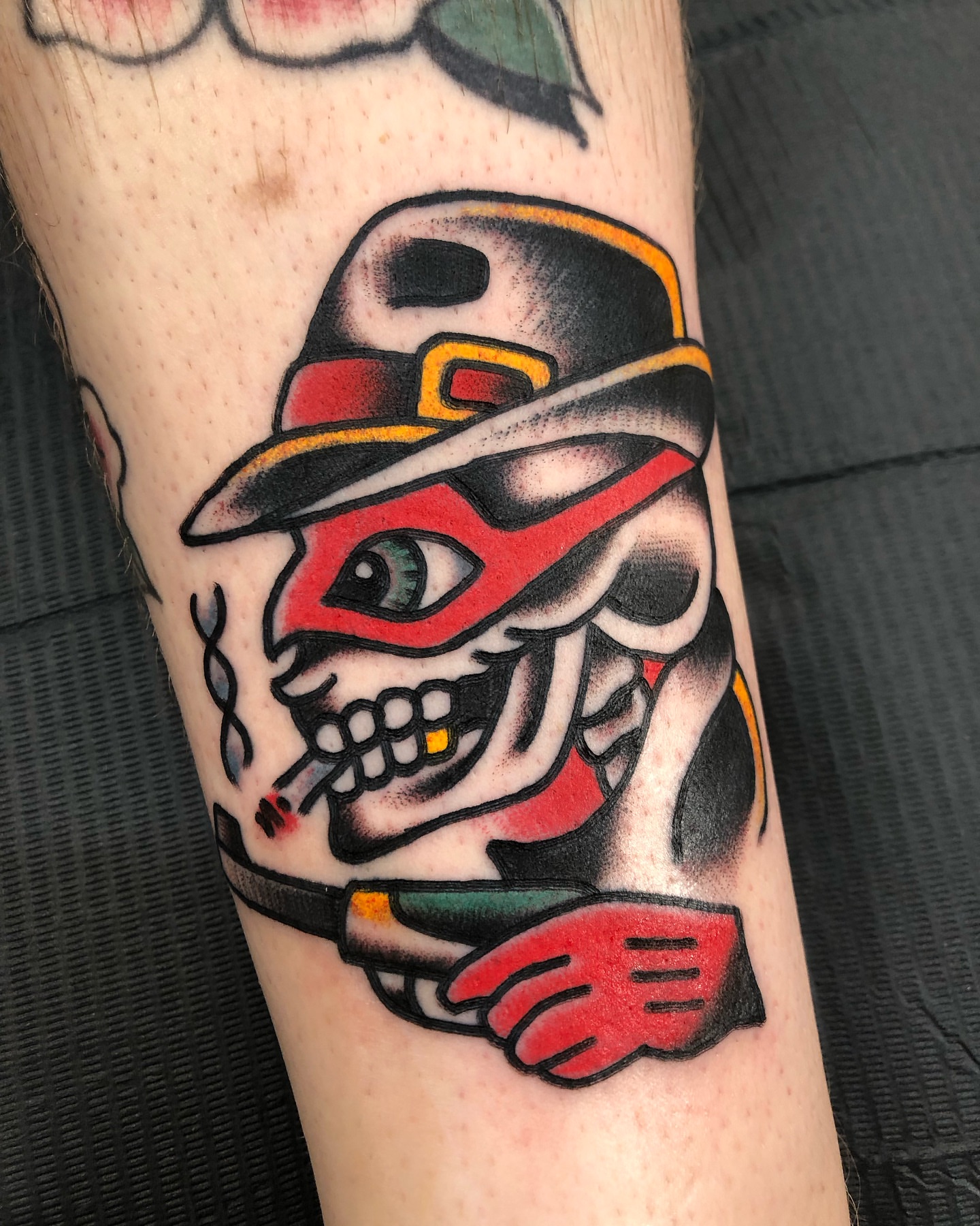 Skull wearing hat American traditional tattoo on the forearm by Nick Sharratt, Chicago, Illinois
