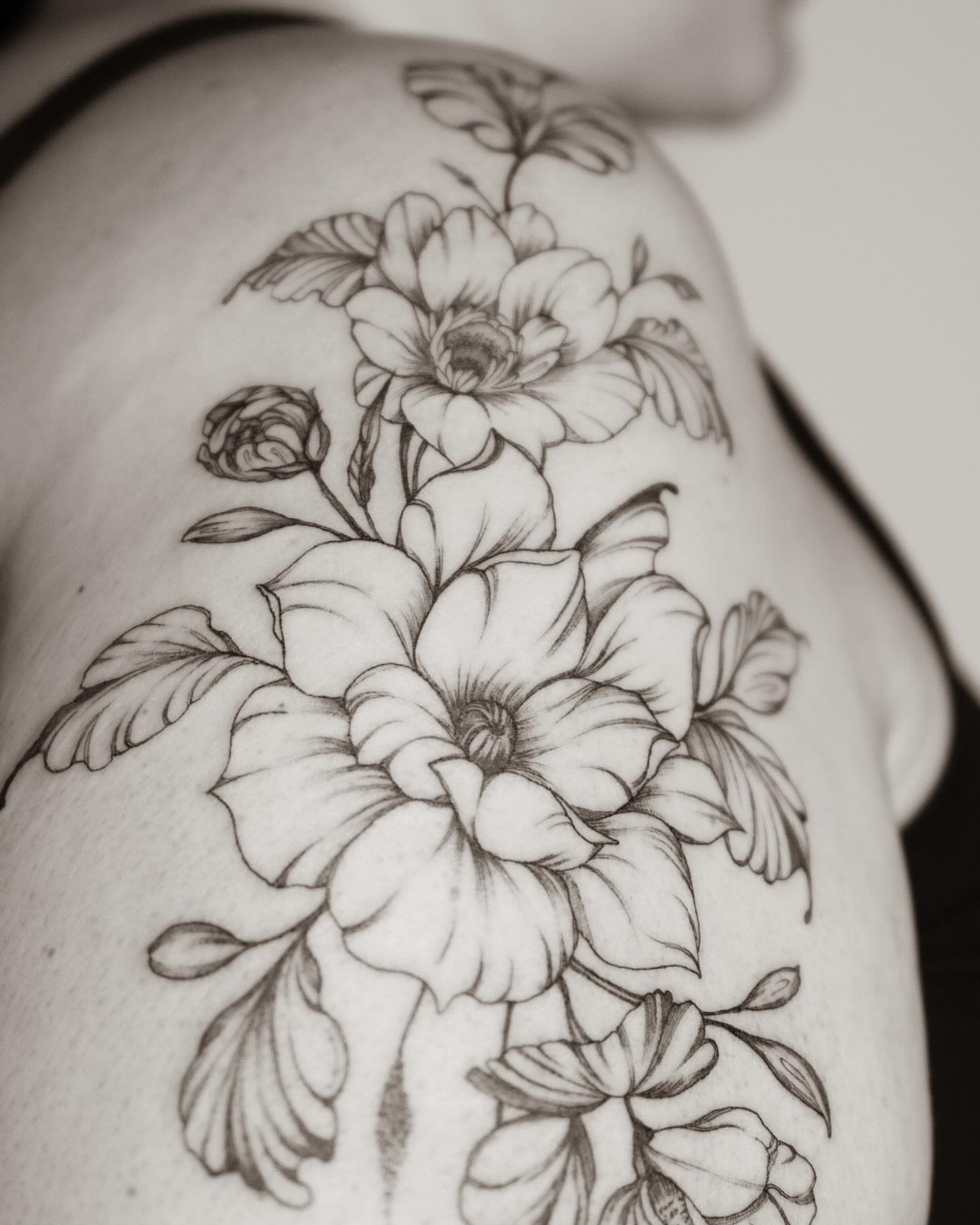 Floral bouquet black and grey tattoo on the shoulder by Seraphim