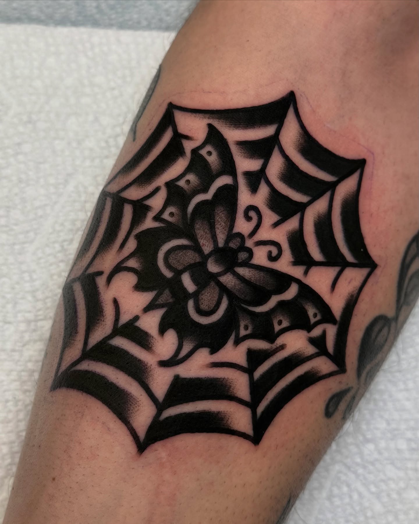 Spider web black and grey tattoo on the forearm by Zachary - Traditional Tattoo Artist