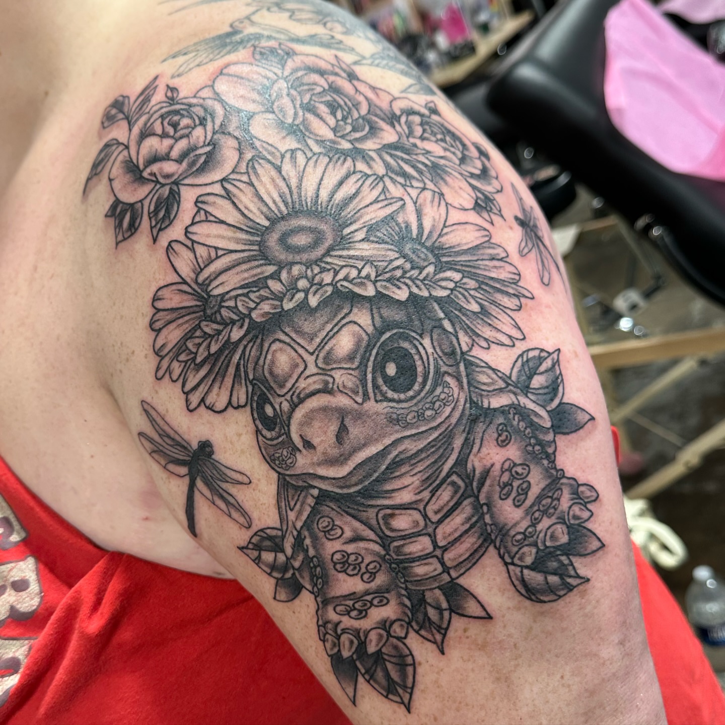Turtle with floral crown realism tattoo on the shoulder by Emily K Lingg