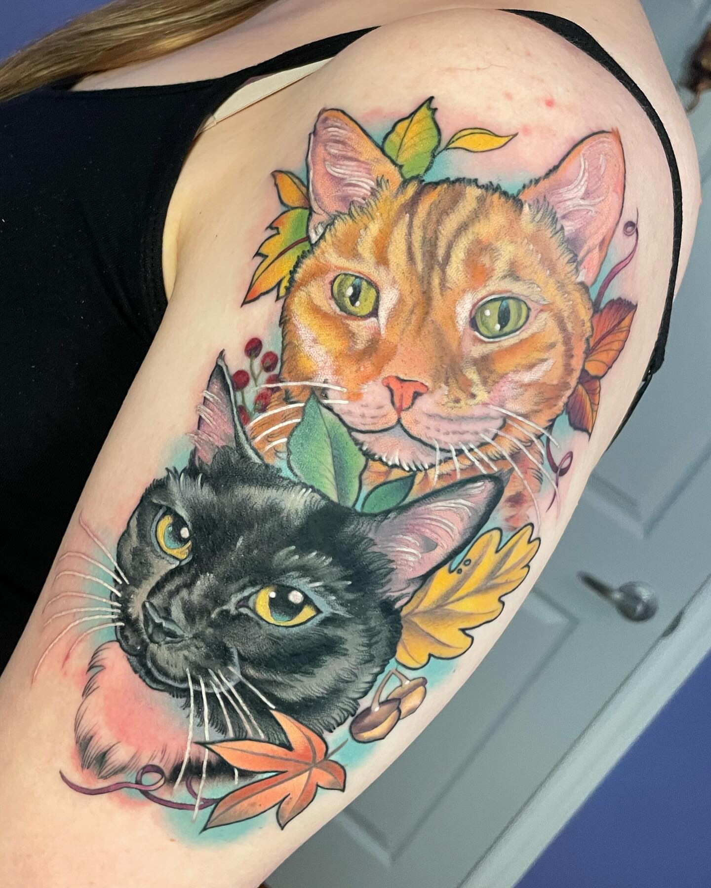 Cats realism tattoo on the upper arm by Sarah Baldwin