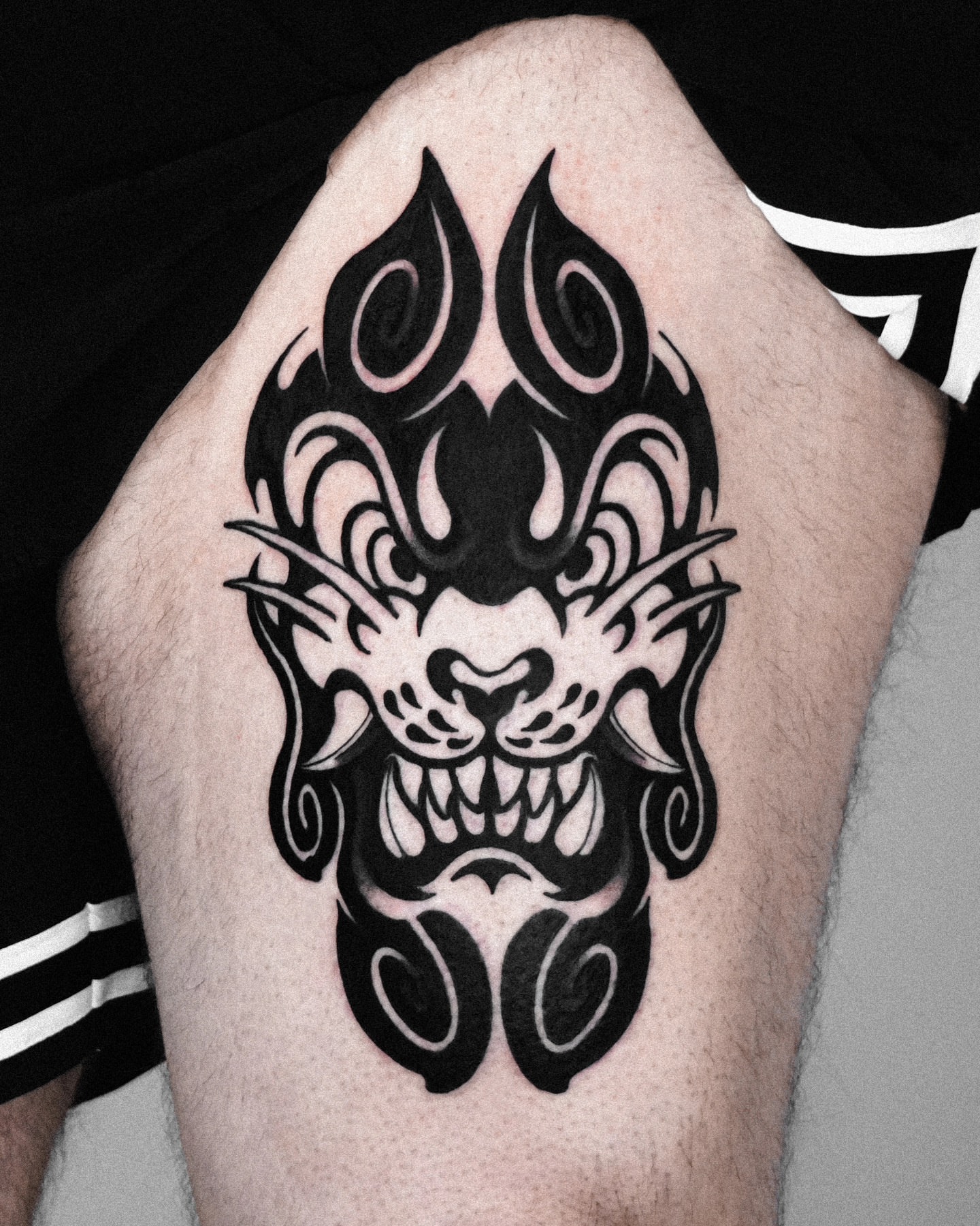 Demon face black and grey tattoo on the thigh by Jeremy "Jerms" Camposanto