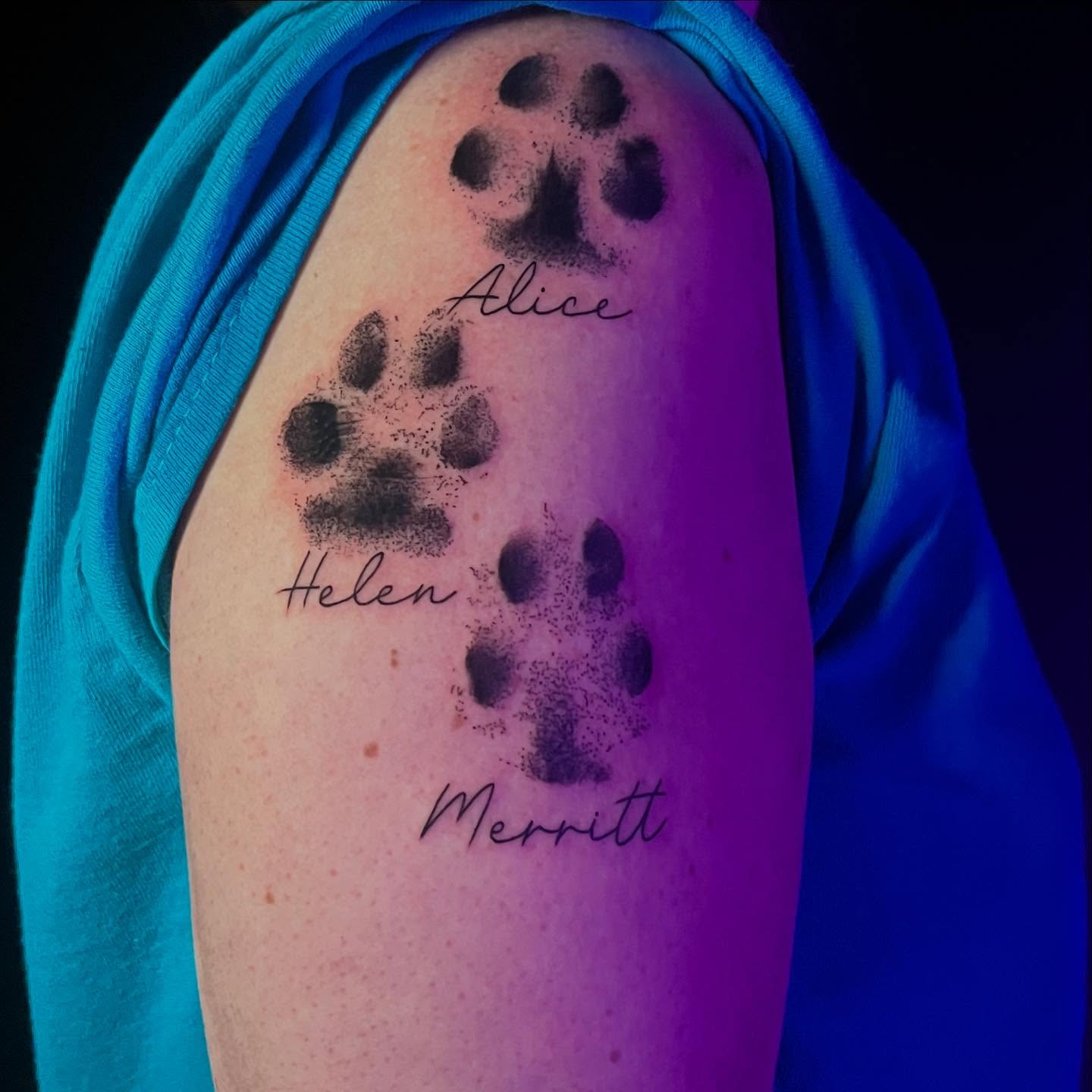 Paw prints dotwork tattoo on the forearm by Lexi Ross