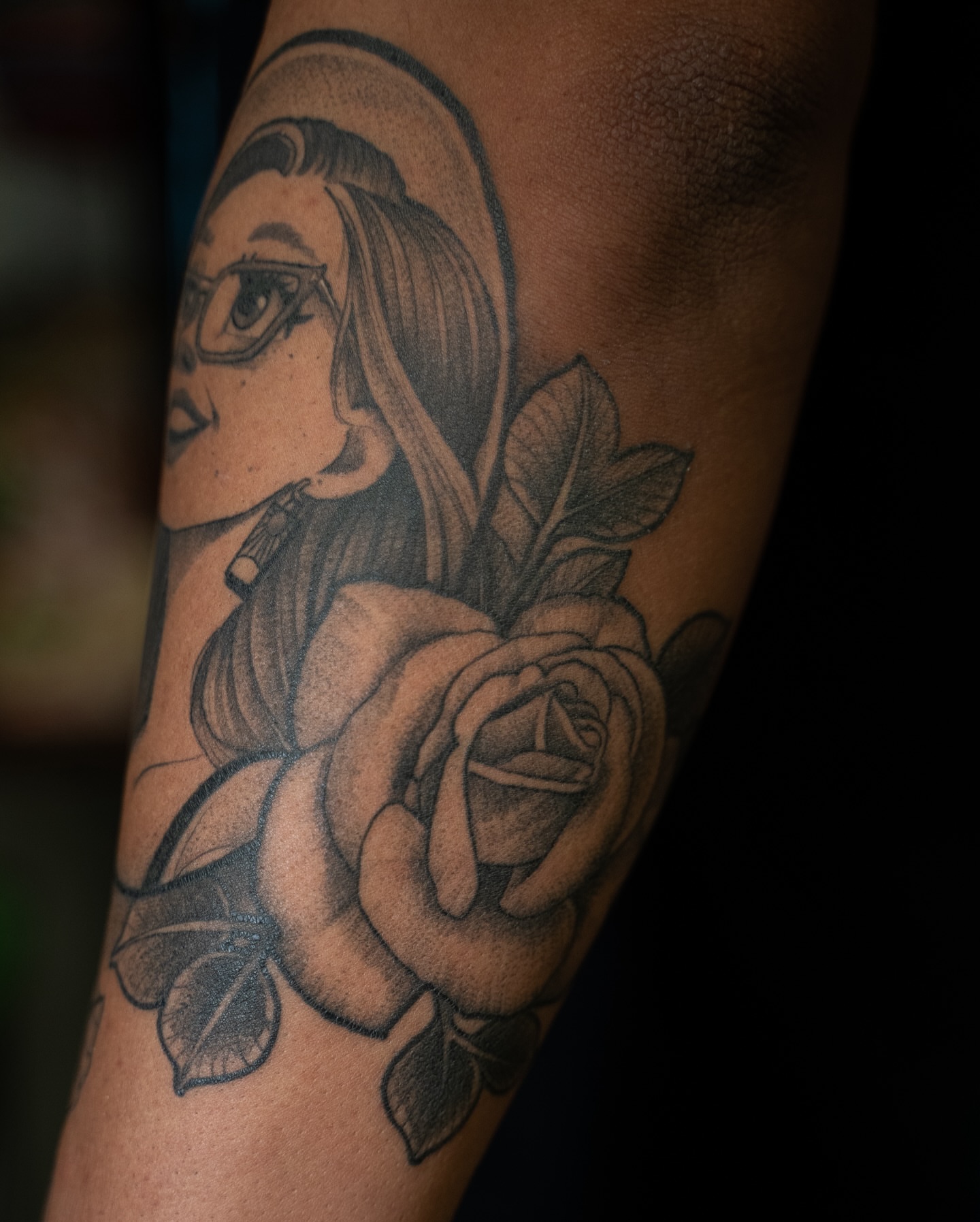 Woman with rose realism tattoo on the forearm by Chris Estrada