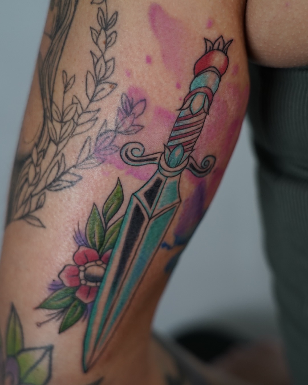 Sword and floral American traditional tattoo on the forearm by Tattoo Artist πΊπΈ