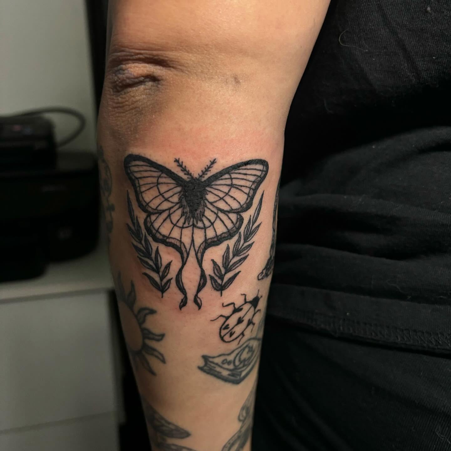 Butterfly black and grey tattoo on the forearm by Victoria