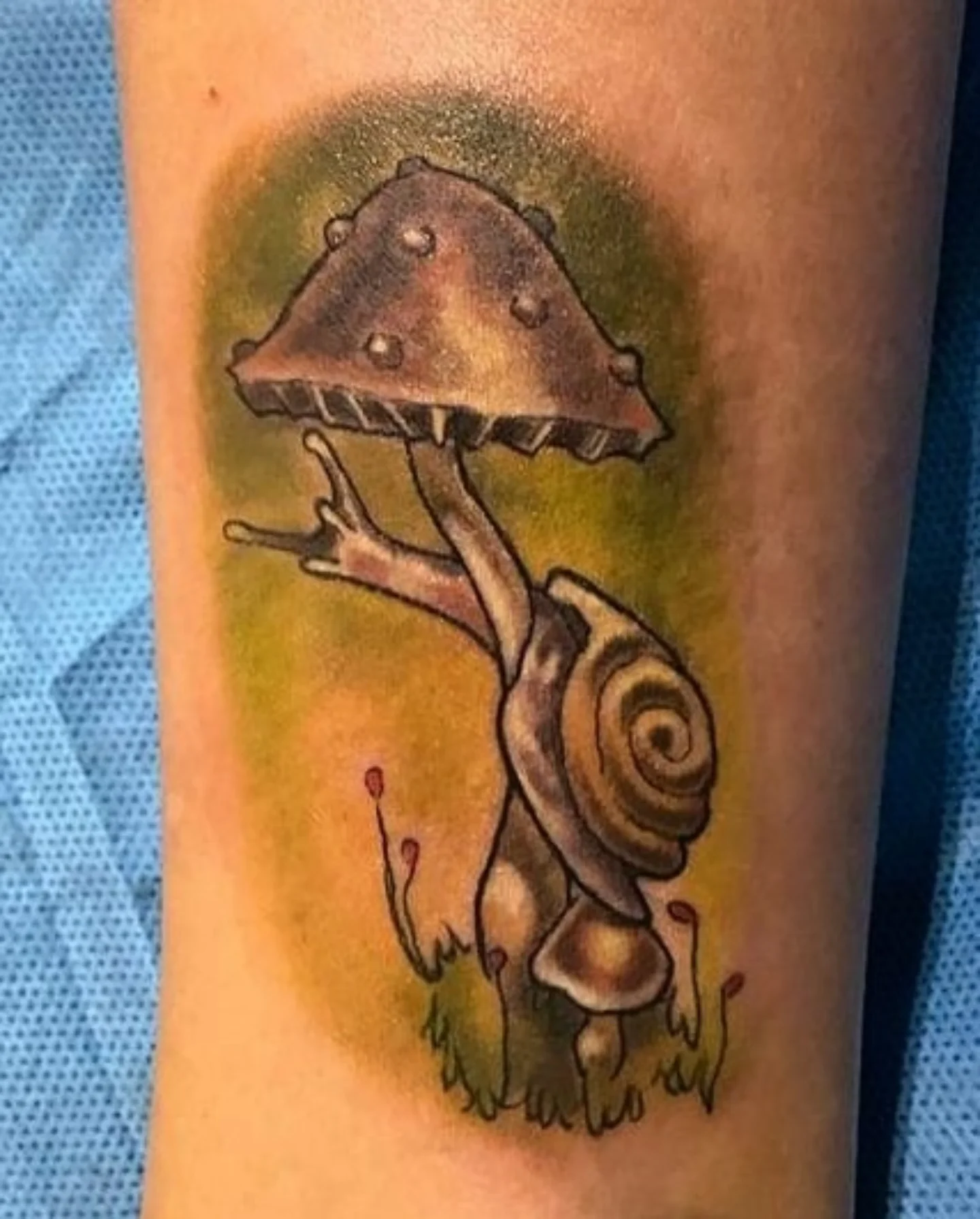 Snail and mushroom American traditional tattoo on the forearm by Lahel (Lay-el) Fowler