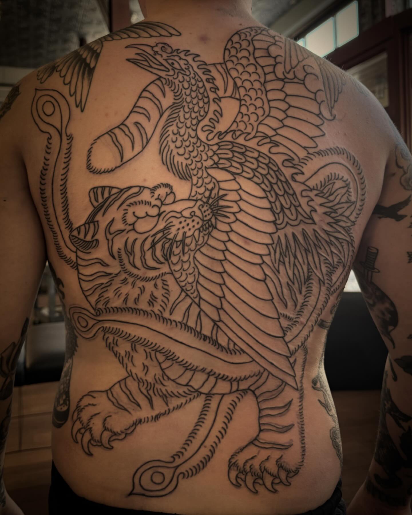 Mythical creature black and grey tattoo on the back by Jesse Swanson, Santa Rosa, California
