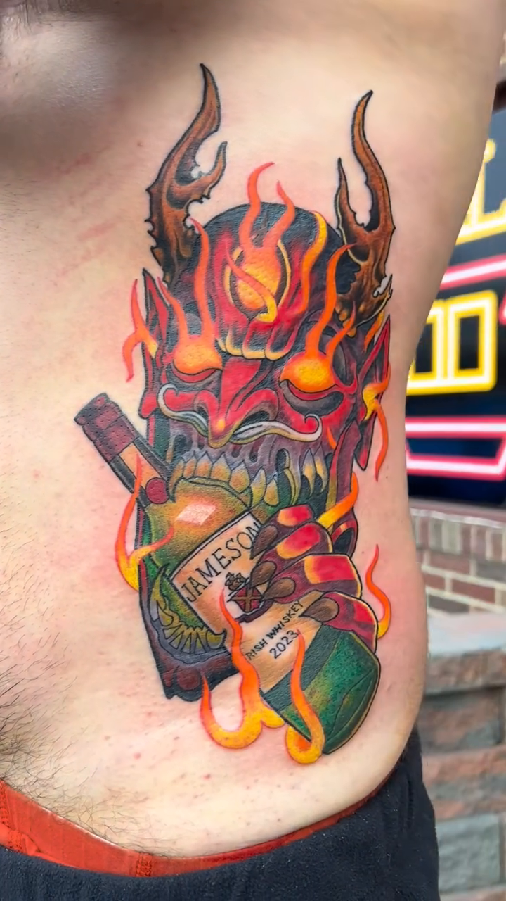 Demon mask and whiskey bottle neo-traditional tattoo by Adam Zgorliski_STStattoo