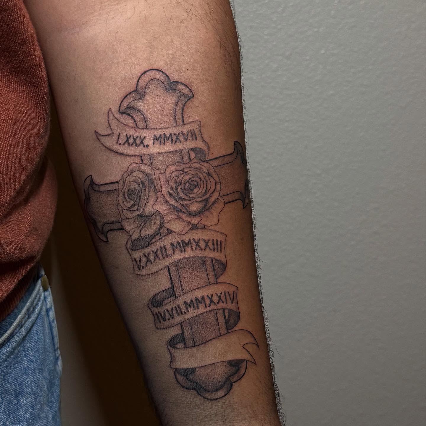 Cross with roses black and grey tattoo on the forearm by Elian Sanchez Austin Tx. Tattoo Artist