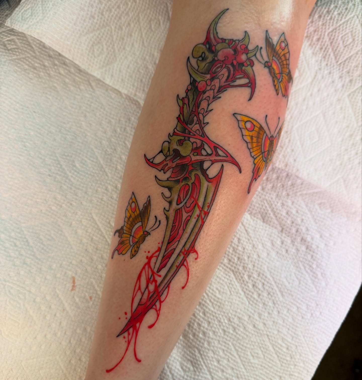 Winged dagger with butterflies neo-traditional tattoo on the forearm by Scott Kulikowski