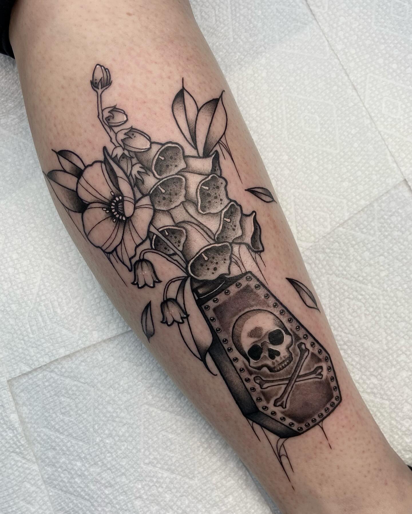 Flowers and skull realism tattoo on the forearm by ππππππ