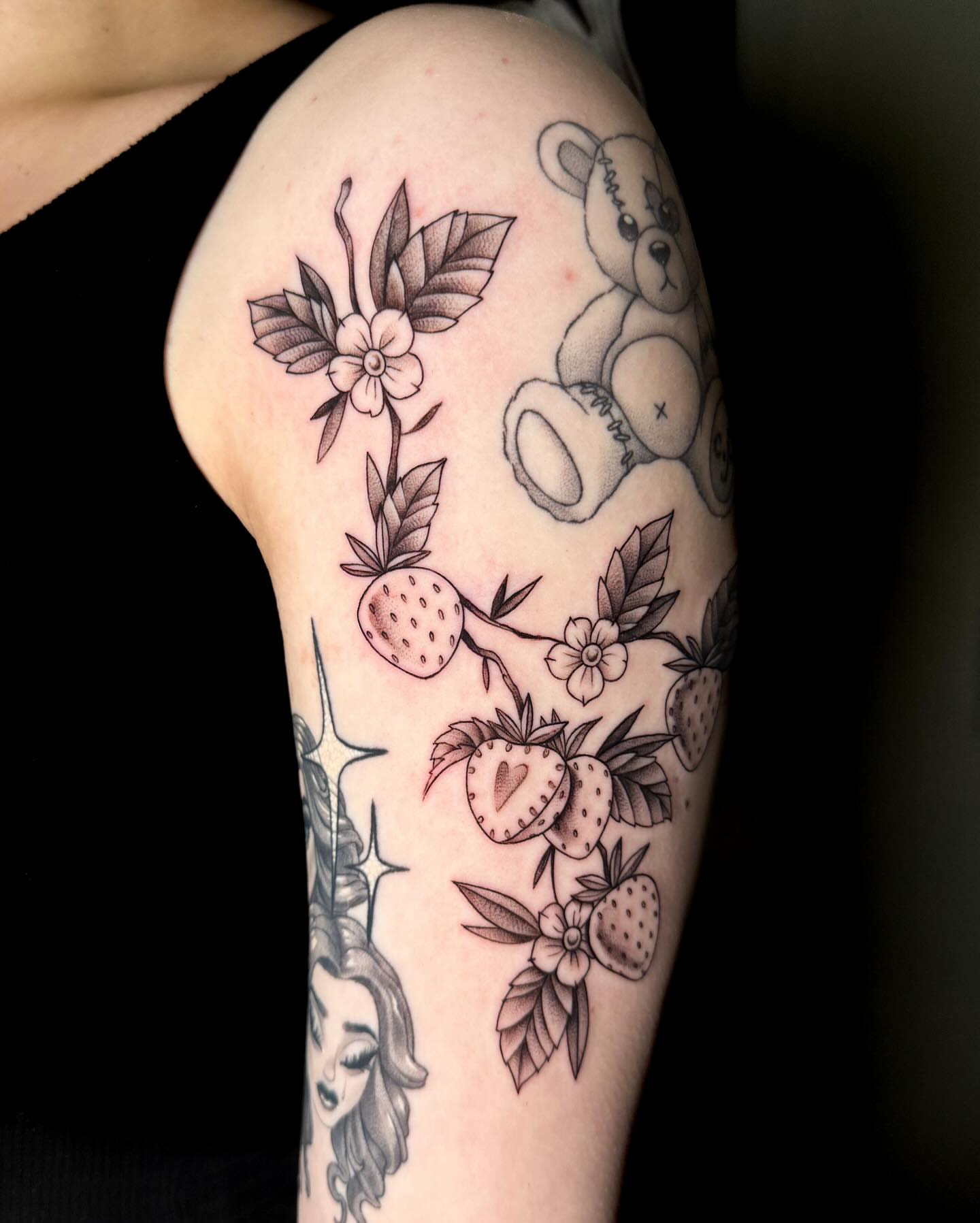 Strawberries and flowers black and grey tattoo on the forearm by Demi DiMartino