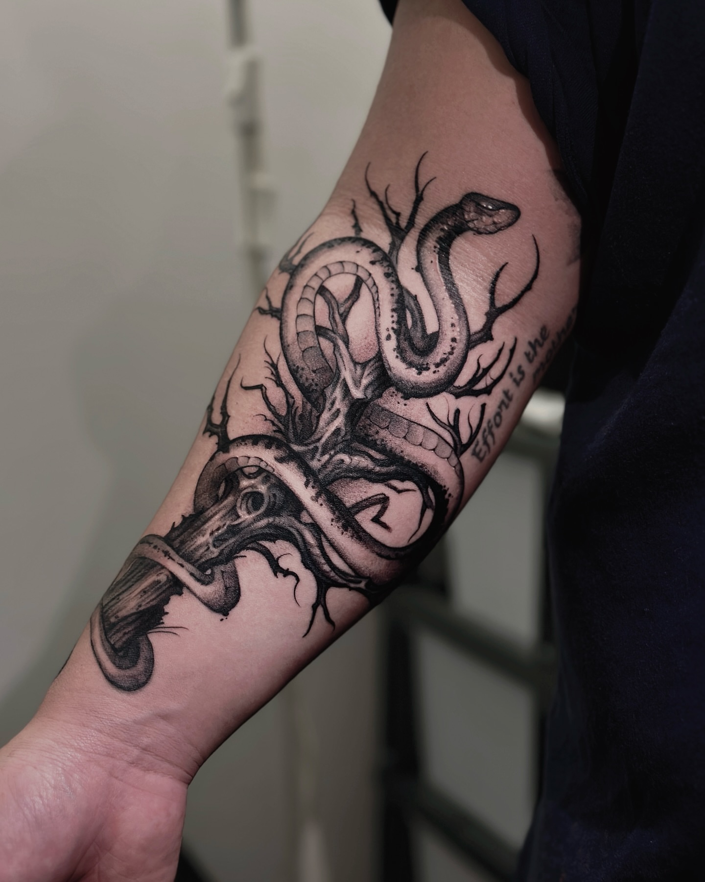Snake black and grey tattoo on the forearm by 두식