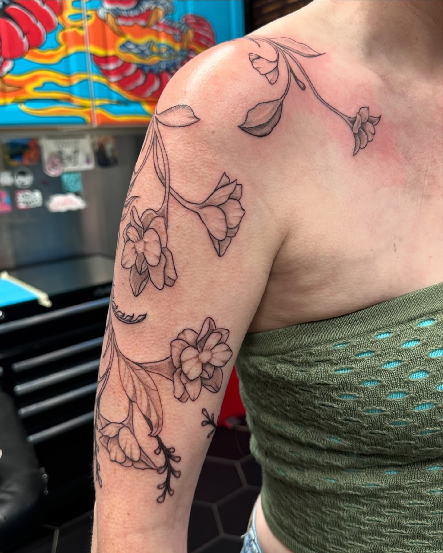 Floral arrangement black and grey tattoo on the upper arm by Shannon, Cincinnati, Ohio