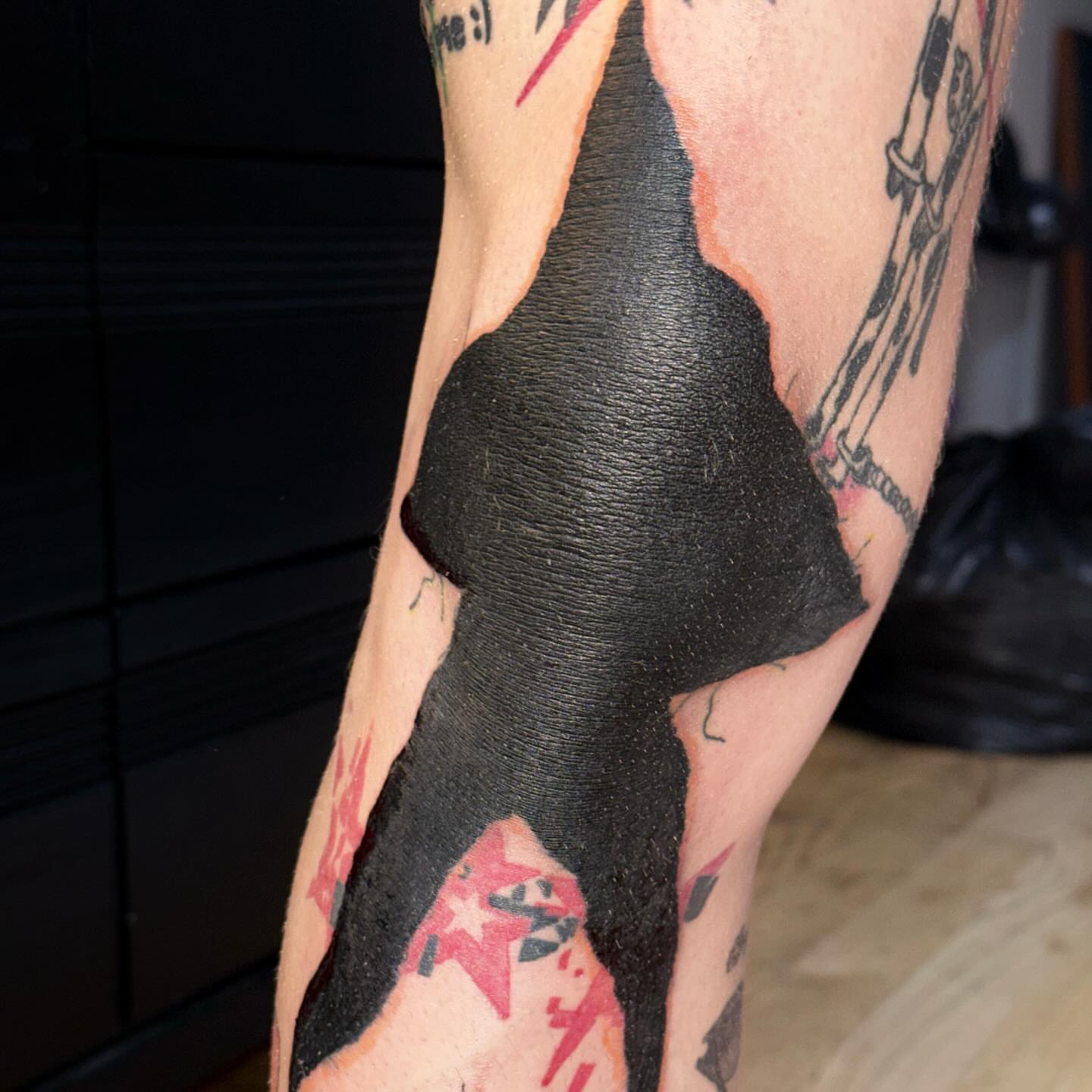 Abstract shape blackwork tattoo on the leg by @godsfirmgrip