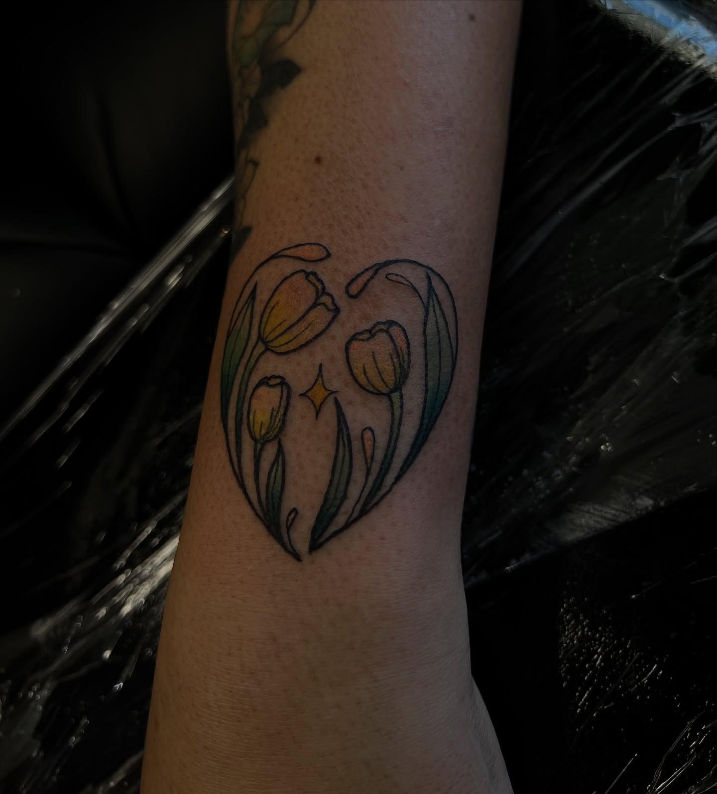 Tulips new school tattoo on the forearm by Stevie Reign