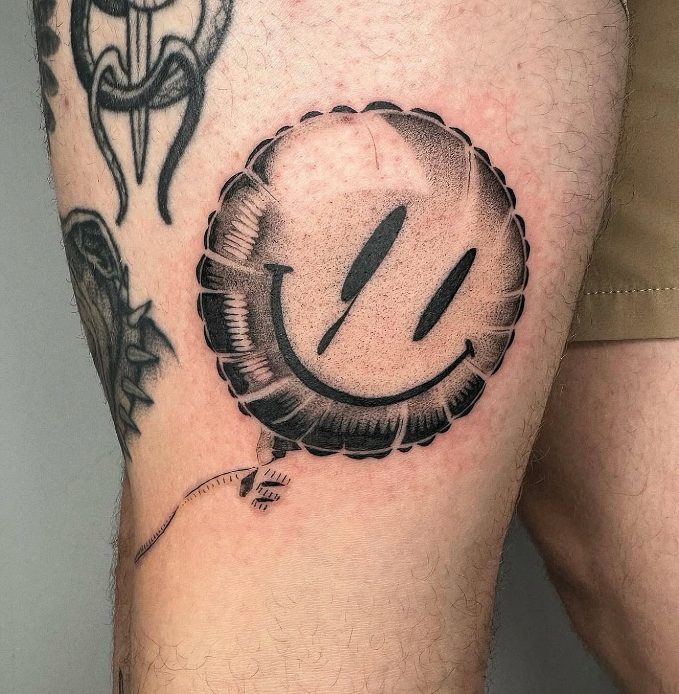 Smiley face dotwork tattoo on the forearm by Jenni Palomaa