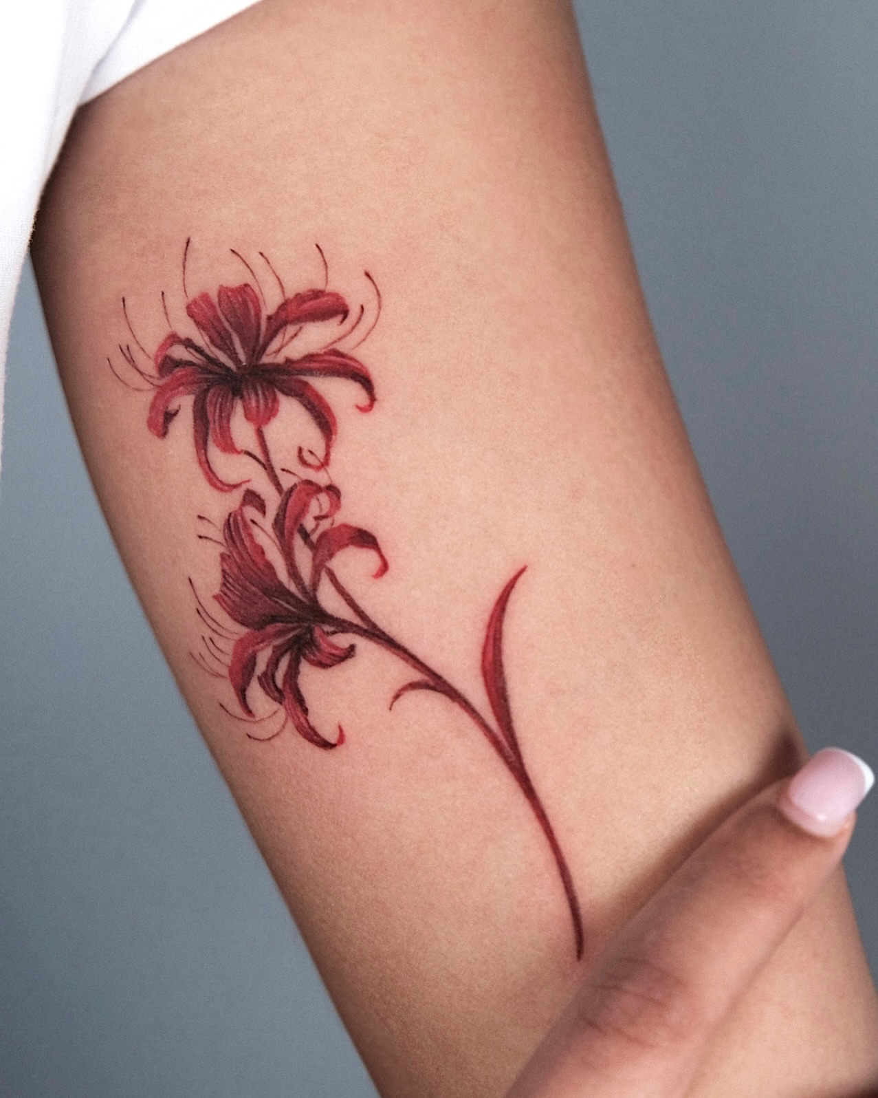 Red lilies realism tattoo on the forearm by Da-An ･ﾟ✧ 다 안 𓇬˖