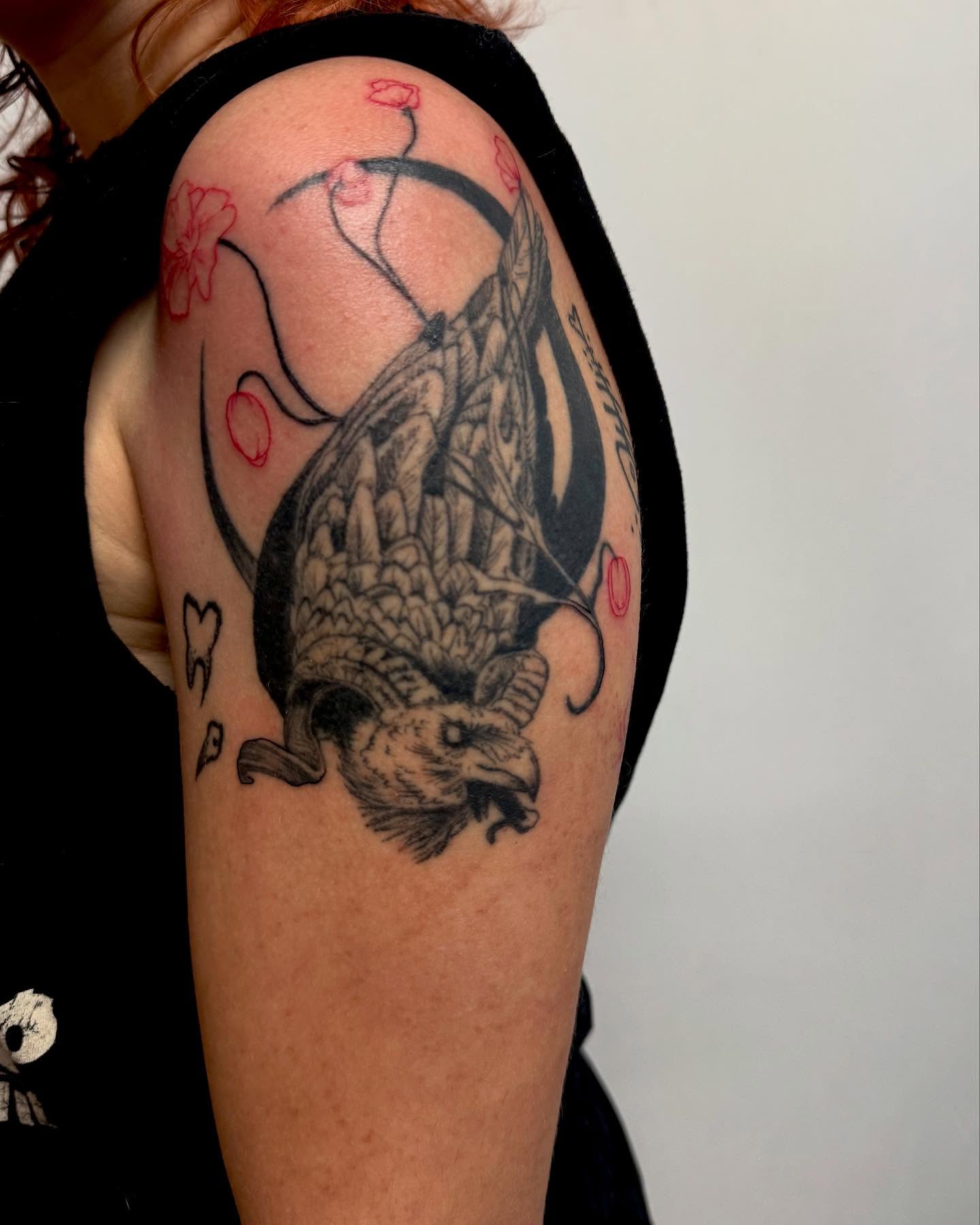 Eagle black and grey tattoo on the upper arm by Christen Wolfe CA Tattooer
