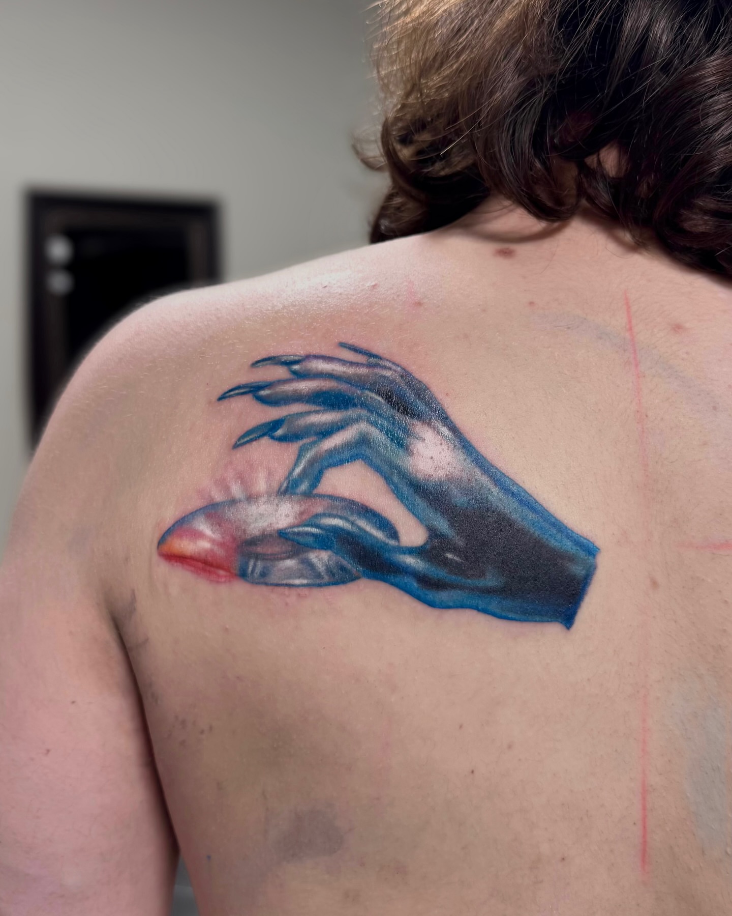 Hand with glowing orb realism tattoo on the back by Suda