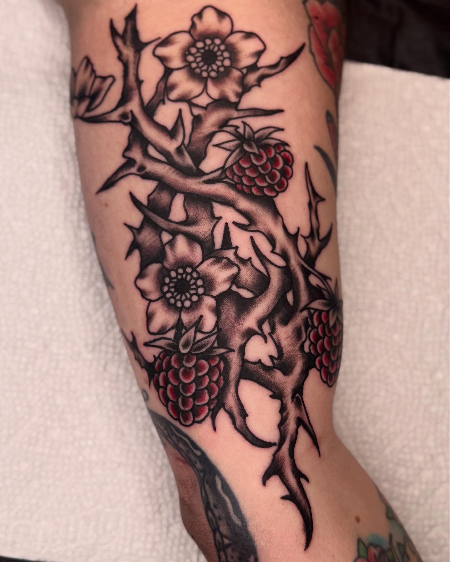 Flower and thorn black and grey tattoo on the forearm by Meg Nefcy, Milford, Michigan