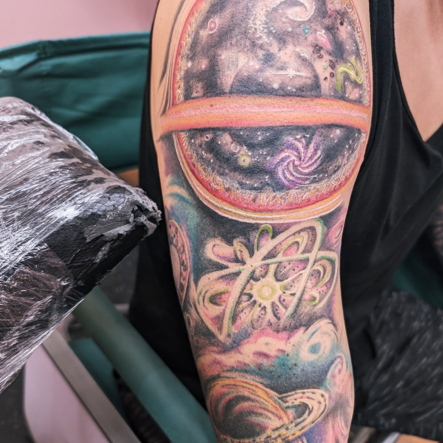 Galactic nebula surrealism tattoo on the forearm by Markus Hicks