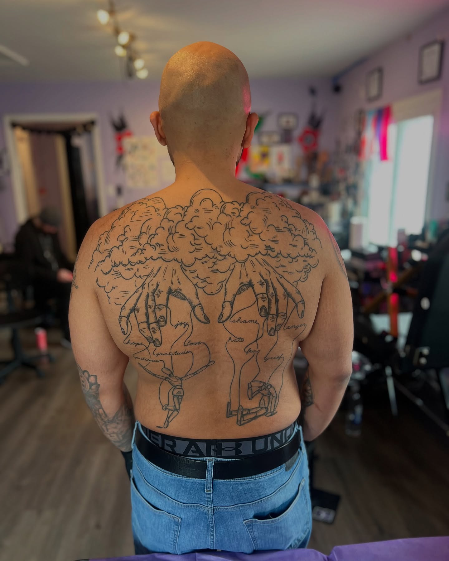 Clouds and hands black and grey tattoo on the back by Rose DeLisse