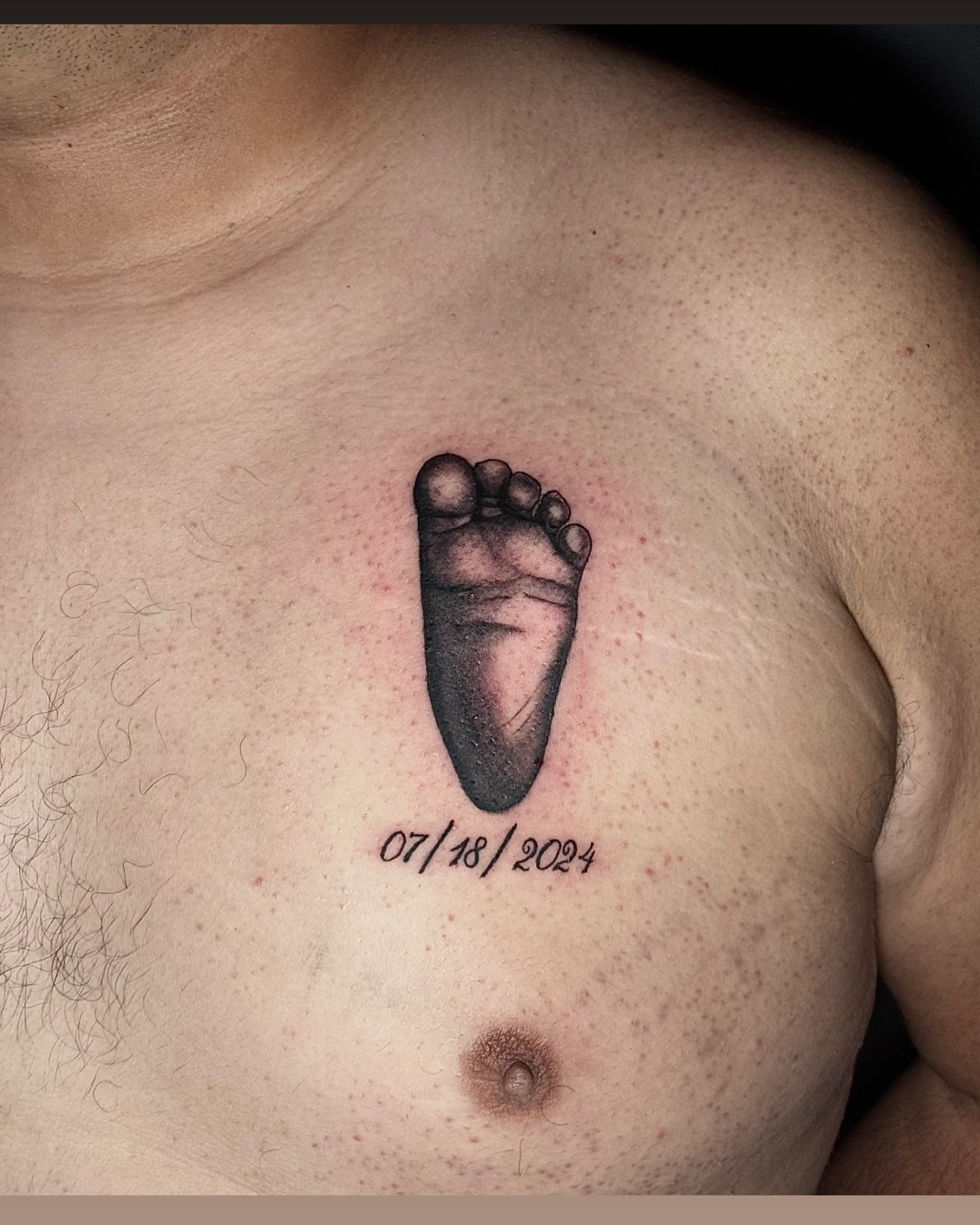 Baby foot black and grey tattoo on the chest by David