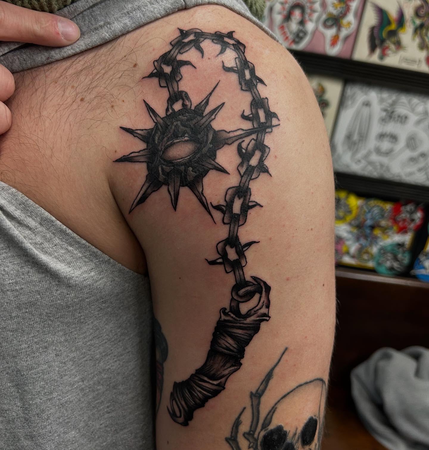 Barbed chain and spiked key black and grey tattoo on the shoulder by Kylee langford 🧿