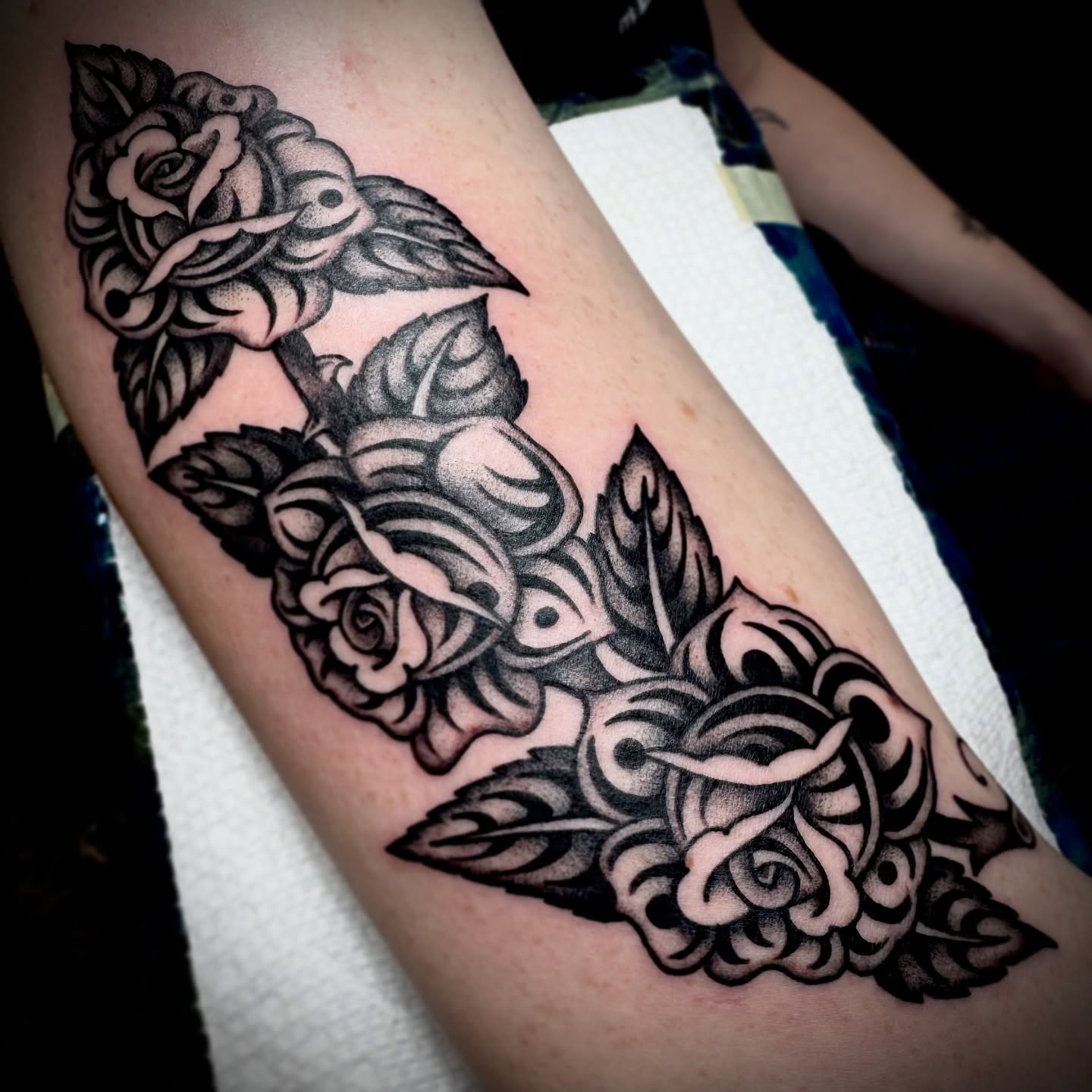 Roses American traditional tattoo on the forearm by Kristen