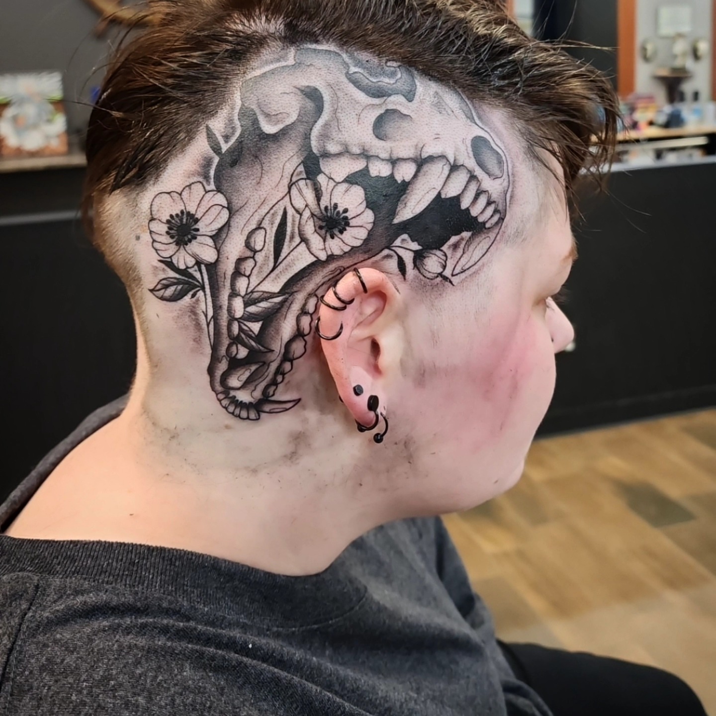 Skull and flowers black and grey tattoo on the head by bobby allensworth