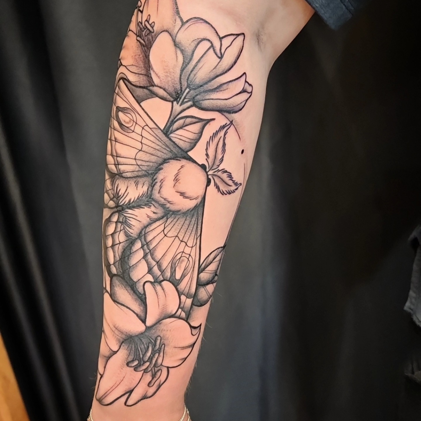 Bee and flowers realism tattoo on the forearm by bobby allensworth