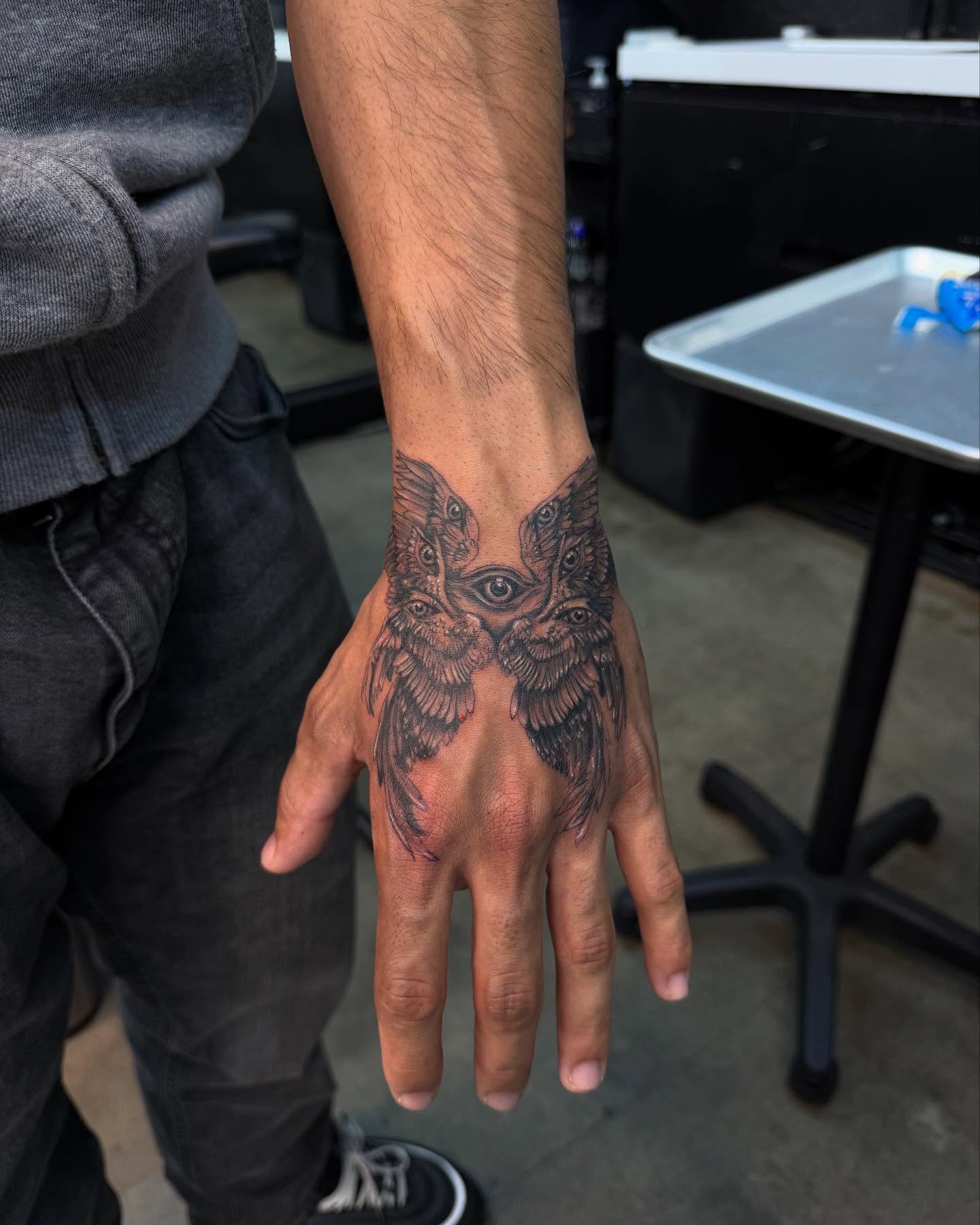 Owl faces black and grey tattoo on the hand by viktoria raquel