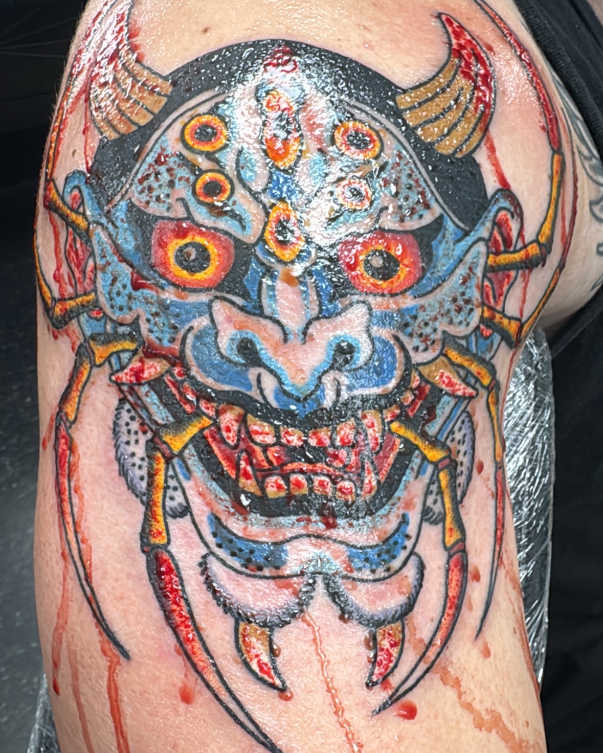 Demon mask japanese irezumi tattoo on the thigh by Timothy Wood