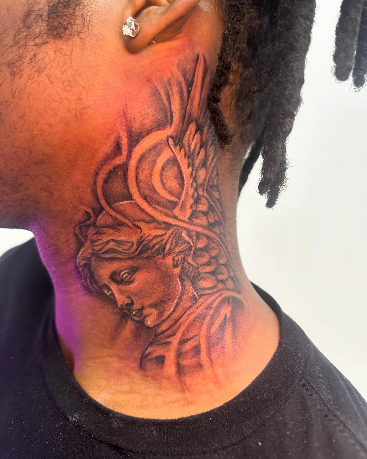Medusa head realism tattoo on the neck by The Ink Guru.