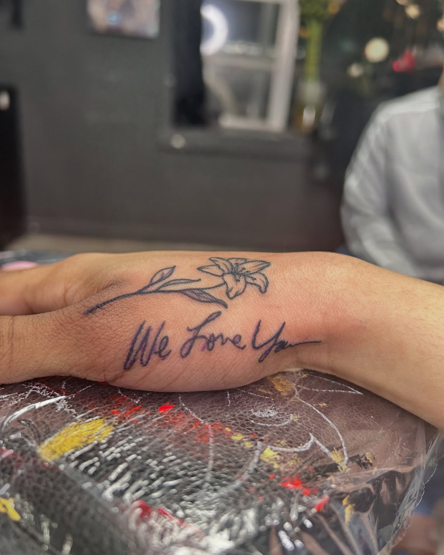 We Love Ya lettering script tattoo on the forearm by Vanessa - Dallas Artist