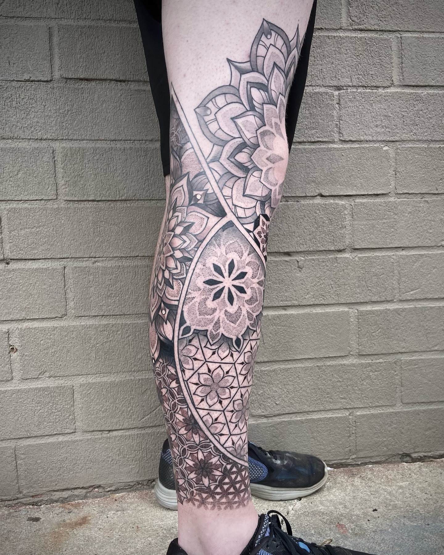 Mandala geometric tattoo on the calf by Zac Byrd